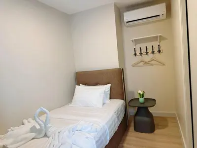 a small bedroom with a bed and a table at The Atrium at Jalan Ampang by OKBnB - Modern Stylish 2Bedroom with FREE WiFi and Carpark in Kuala Lumpur