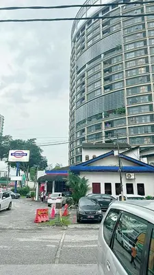 a parking lot with cars parked in front of a large building at The Atrium at Jalan Ampang by OKBnB - Modern Stylish 2Bedroom with FREE WiFi and Carpark in Kuala Lumpur