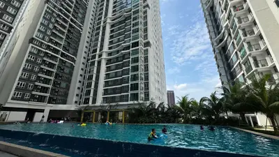 a swimming pool in the middle of two tall buildings at MH Platinum 2 COZY Fully Air-Con Suite Kuala Lumpur in Kuala Lumpur