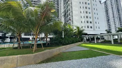 a park with palm trees in a city with buildings at MH Platinum 2 COZY Fully Air-Con Suite Kuala Lumpur in Kuala Lumpur