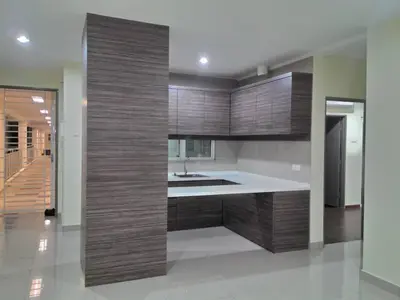 a kitchen with wooden cabinets and a sink at Zetapak homestay in Kuala Lumpur