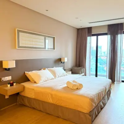 a bedroom with a large bed with two towels on it at 188 Suites KLCC Hotel with bathtub in KL in Kuala Lumpur