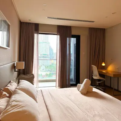 a bedroom with a large bed with a large window at 188 Suites KLCC Hotel with bathtub in KL in Kuala Lumpur