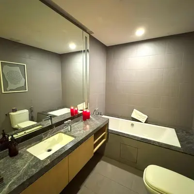 a bathroom with a sink and a tub and a mirror at 188 Suites KLCC Hotel with bathtub in KL in Kuala Lumpur