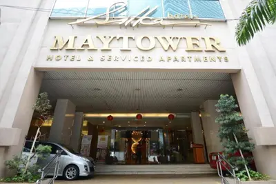 a car parked outside of a mayflower hotel and serviced apartments at Gastfamilie maytower in Kuala Lumpur