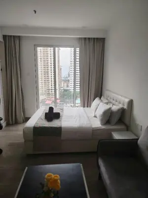 a bedroom with a large bed and a large window at 1Bukit ceylon view 118 in Kuala Lumpur