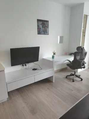 a white office with a desk and a monitor and a chair at 1Bukit ceylon view 118 in Kuala Lumpur