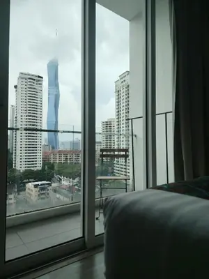 a bedroom with a view of a city from a window at 1Bukit ceylon view 118 in Kuala Lumpur