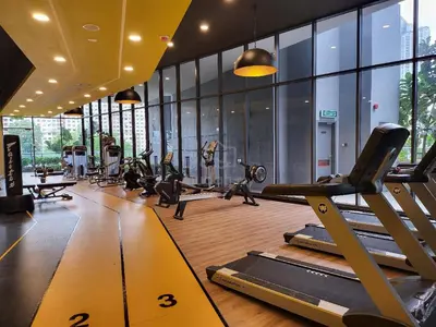 a gym with treadmills and pilates equipment and windows at KL City, Neu Suites 2Bedroom 1Bathroom in Kuala Lumpur
