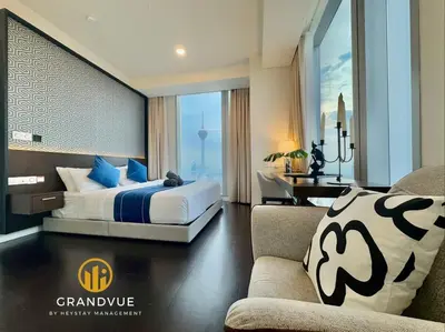 a hotel room with a bed and a desk at Luxury Tropicana The Residence SkyPool KlccView CityCenter By HeyStay Management in Kuala Lumpur