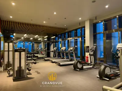 a gym with treadmills and ellipticals in a building at Luxury Tropicana The Residence SkyPool KlccView CityCenter By HeyStay Management in Kuala Lumpur