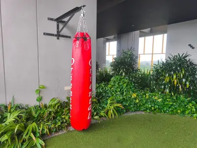 a red object hanging from the side of a building at 8Pax Green View next to KL118 ChinaTown n Train Station in Kuala Lumpur