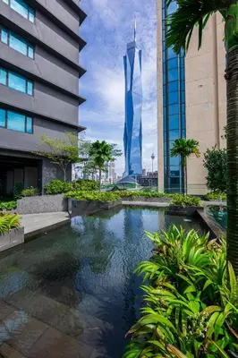 a swimming pool in front of a tall building at 8Pax Green View next to KL118 ChinaTown n Train Station in Kuala Lumpur
