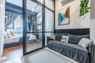 a living room with a couch and a bedroom at 6pax 2BR KL118 View 5min to train Station in Kuala Lumpur