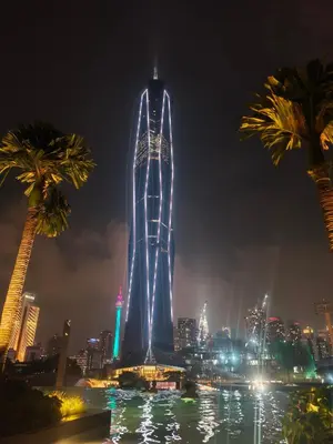 a tall building with lights on it at night at 6pax 2BR KL118 View 5min to train Station in Kuala Lumpur