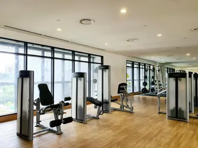 a gym with treadmills and chairs in a room at The Establisment KL Sentral by GBS in Kuala Lumpur