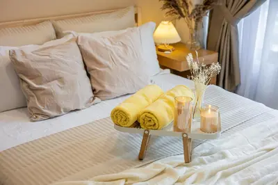 a tray with towels and candles on a bed at TRX View Muji Room 5 min to Bukit Bintang at Agile in Kuala Lumpur