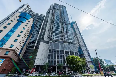 a tall building with cars parked in front of it at TRX View Muji Room 5 min to Bukit Bintang at Agile in Kuala Lumpur