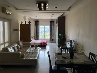 a living room with a couch and a table at Cosy Studio Apartment at Hartamas in Kuala Lumpur