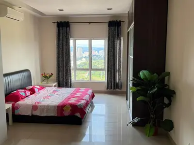 a bedroom with a bed and a large window at Cosy Studio Apartment at Hartamas in Kuala Lumpur