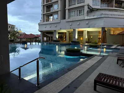 a large swimming pool in front of a building at Cosy Studio Apartment at Hartamas in Kuala Lumpur