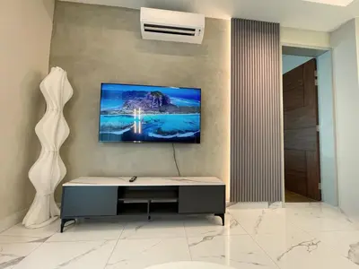 a room with a desk and a painting on the wall at Alfa Bangsar by The Homez in Kuala Lumpur