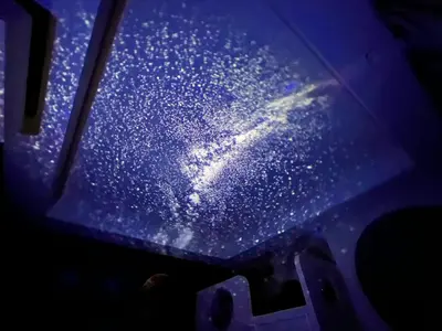 a close up of a window of a plane with stars at Alfa Bangsar by The Homez in Kuala Lumpur