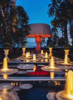 a lit up fountain with a lamp in the middle at Duplex Arte Mont kiara 2 bedroom in Kuala Lumpur
