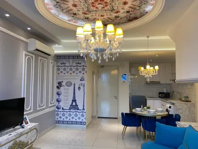 a living room with a dining table and a chandelier at Arte mont kiara duplex 2 bedroom in Kuala Lumpur