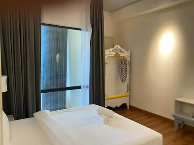 a bedroom with a white bed and a window at Arte mont kiara duplex 2 bedroom in Kuala Lumpur