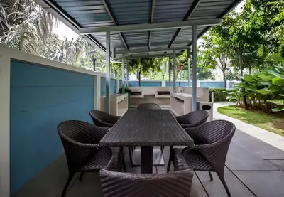 a wooden table and chairs on a patio at Suasana Bukit Ceylon by Goldcrests Global in Kuala Lumpur