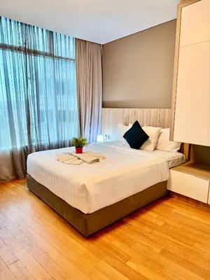 a bedroom with a large bed in front of a window at Vortex Suites By Asian in Kuala Lumpur