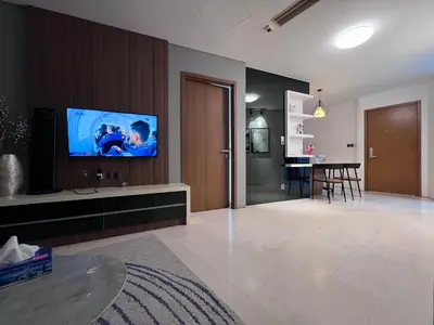 a living room with a flat screen tv on a wall at Vortex Suites By Asian in Kuala Lumpur