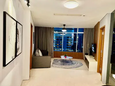 a living room with a couch and a table at Vortex Suites By Asian in Kuala Lumpur