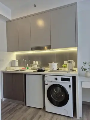 a kitchen with a washing machine and a washer at Design House Kuala Lumpur #P3 in Kuala Lumpur