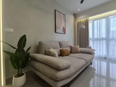 a living room with a couch and a plant at Design House Kuala Lumpur #P3 in Kuala Lumpur