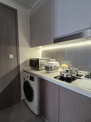 a kitchen with a washing machine and a microwave at Design House Kuala Lumpur #P3 in Kuala Lumpur