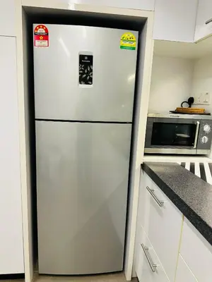 a refrigerator in a kitchen with three stickers on it at The Establishment LOFT Bangsar KL Sentral by \u54c1\u5c4b PINWU Shortstay in Kuala Lumpur