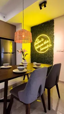 a dining room with a table and chairs with a neon sign at Agile Kuala Lumpur 4min TRX Pavillion #P8 in Kuala Lumpur