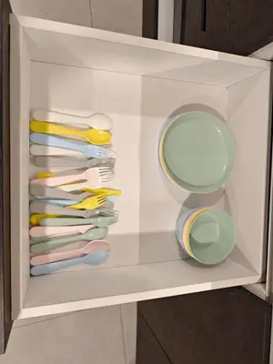 a drawer filled with different colored plates and bowls at The Atrium Jalan Ampang KLCC in Kuala Lumpur
