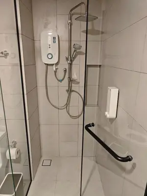 a shower in a bathroom with a glass door at The Atrium Jalan Ampang KLCC in Kuala Lumpur