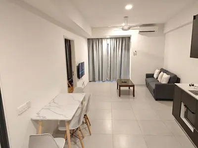 a living room with a table and a couch at The Atrium Jalan Ampang KLCC in Kuala Lumpur