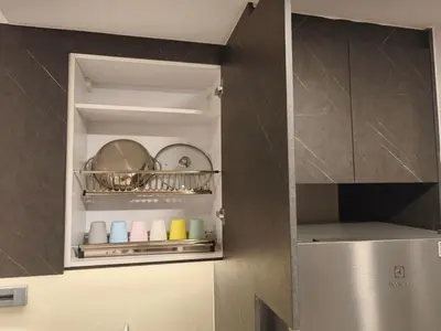 a kitchen with a cupboard with plates and pans at The Atrium Jalan Ampang KLCC in Kuala Lumpur