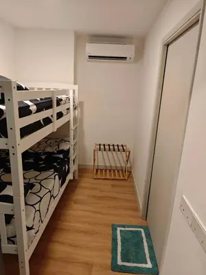 a small room with bunk beds and a fan at The Atrium Jalan Ampang KLCC in Kuala Lumpur