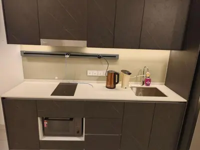 a kitchen counter with a sink and a microwave at The Atrium Jalan Ampang KLCC in Kuala Lumpur