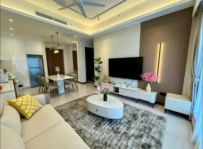 a living room with a couch and a tv at Core Residence at TRX by LL in Kuala Lumpur
