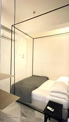 a bed in a room with a glass wall at 2 Bedroom Apartment l City View in Kuala Lumpur