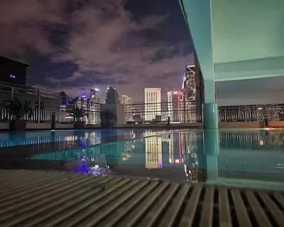 a view of a city at night with a swimming pool at 2 Bedroom Apartment l City View in Kuala Lumpur