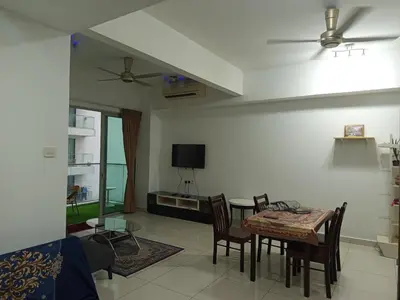 a living room with a table and chairs and a tv at Serene Haven in Kuala Lumpur