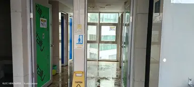 an empty hallway with glass doors in a building at Serene Haven in Kuala Lumpur